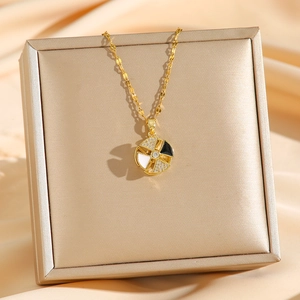 Golden titanium rotating windmill necklace on luxury jewelry box with champagne silk background