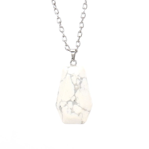 Close-up of natural white turquoise coffin pendant with faceted stone and silver chain