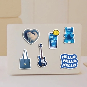 Detailed close-up of blue aesthetic waterproof PVC stickers on a laptop surface