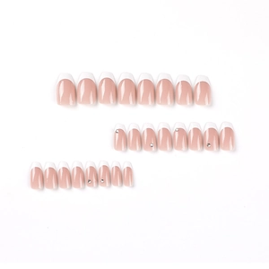 White French tip press-on nails with rhinestones on short ballerina shape