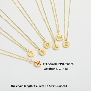 Minimalist gold letter pendant necklaces with sparkling crystals on white background