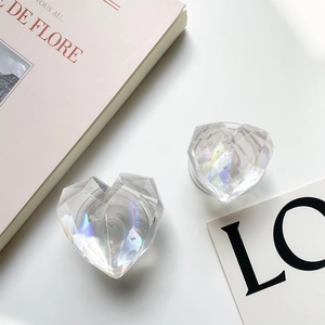 Detail of holographic heart-shaped phone grip with diamond-cut faceted resin surface