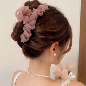 Elegant dusty pink pleated mesh claw clip for women's updos shown on a model