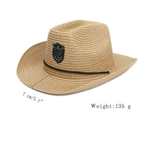 Detail of woven straw cowboy hat with bull head emblem showing 7cm brim and 135g weight