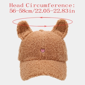 Detail of plush baseball cap with teddy fleece, cute ears, and pink heart embroidery
