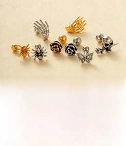 Gothic punk stud earrings set featuring skull and rose designs in silver and gold steel