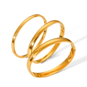 Three-piece set of polished gold titanium steel bangles with secure hinge closure