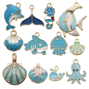 Detailed set of blue enamel marine charms including shells, dolphins and seahorses