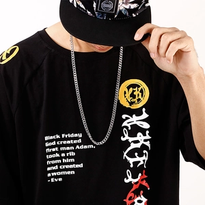 Close-up of black street style T-shirt with white text print on a male model