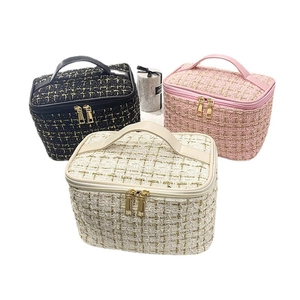 Quilted tweed makeup bags in black, pink, and beige with gold zippers and leather handles