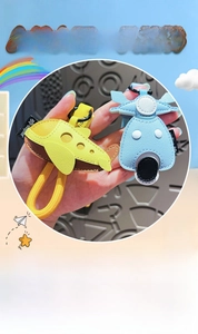 Detail of cartoon leather airplane and blue scooter pendants with litchi texture