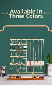 Detail of gold metal jewelry organizer with dark wood base and beige velvet watch holder