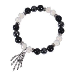 Close-up of gothic beaded bracelet with black stones and silver skeleton hand charm