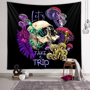 Detail of mushroom tapestry with skull art and Let's TAKE a TRIP text on brick wall