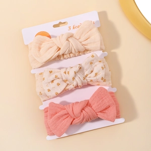 Detailed set of three ribbed baby headbands featuring floral and solid bow designs