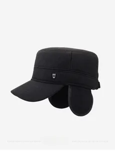 Detail view of winter black flat cap featuring thick fabric and sport metal logo