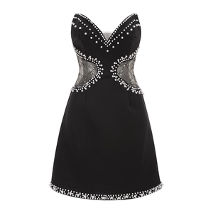 Sexy black sleeveless party dress with pearl trim and waist cut-outs on white background
