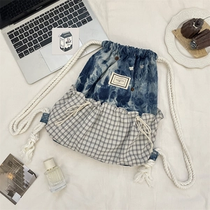 Flachbild eines Karo-Patchwork-Rucksacks mit Laptop und ästhetischem Zubehör-Set