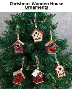 Close-up of wooden Christmas house ornaments with plaid fabric patterns on a Xmas tree