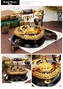 Macro shot of vintage telephone music box with golden rose relief and jewelry drawer