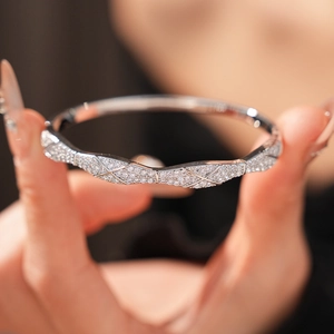 Close-up of silver-tone quilted pave bangle with sparkling cubic zirconia inlay