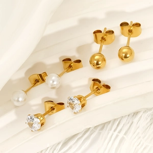 Three-piece set of gold bead, pearl, and zircon titanium steel stud earrings on display