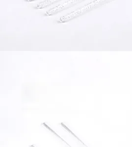 Macro shot of eyelash brushes with transparent glitter-filled handles and spiral bristles