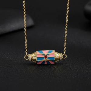 Detail of vintage copper necklace with colorful enamel pendant and red heart zircon