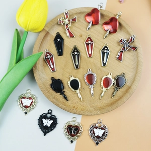 Detailed collection of Halloween gothic metal charms with enamel on a rustic wood tray