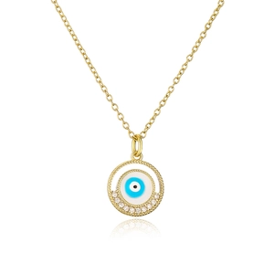 Close-up of golden necklace with evil eye pendant featuring blue enamel and clear crystals