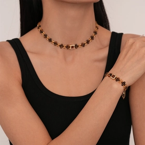 Vintage gold necklace set with tiger eye beads and square zircon pendant on model