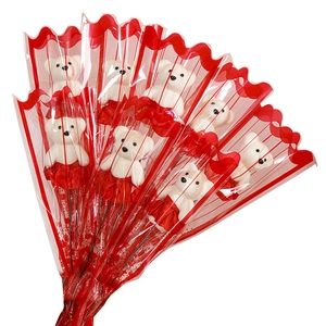 A bouquet of eight white teddy bears in red dresses with elegant clear cone gift wrapping