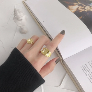Minimalist S925 sterling silver irregular gold rings on aesthetic textured background