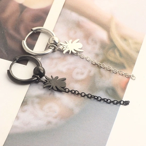 Detailed view of silver and black punk spider earrings with long chain metal tassels