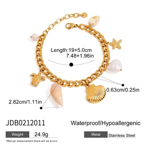 Detail view of 18K gold stainless steel chain bracelet with sea shell charms and pearls