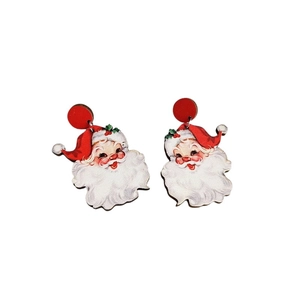 Close-up of retro Santa Claus pendant earrings featuring red and white illustration detail