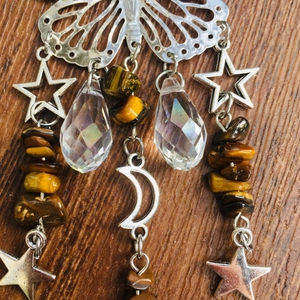 Detail of butterfly suncatcher with tiger eye stones and hanging crystal drops