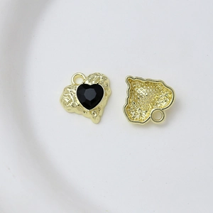Front and back detail of gold alloy heart charms with black stone for DIY jewelry
