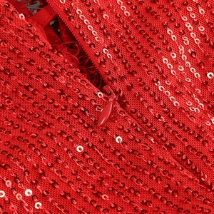 Detail of red sequin fabric featuring a seamless hidden zipper and premium stitching