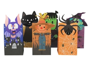 Close-up of Halloween treat bags featuring bats, black cats, and witches cartoon designs