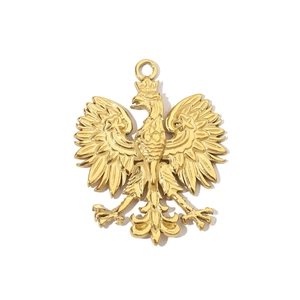 Macro view of golden stainless steel Polish Eagle emblem pendant with relief texture
