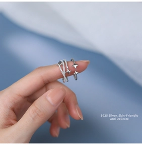 Detailed view of layered S925 sterling silver ring with micro-pave star-shaped zirconias