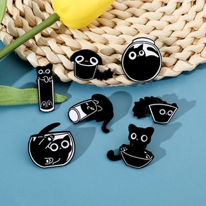 Set of seven cartoon black cat enamel pins in various funny container shapes for bags