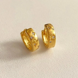 Detailed view of S925 sterling silver gold star earrings with cubic zirconia stones