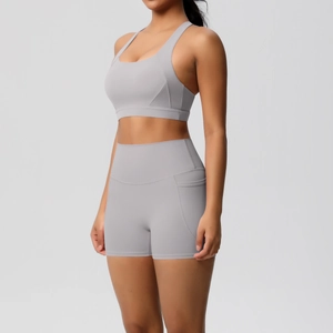 Detail of high-waist yoga shorts with side pocket in a gray seamless fitness two-piece set