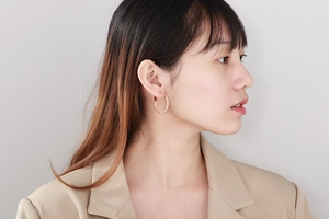Rose gold textured hoop earrings shown on model for a stylish oversized look