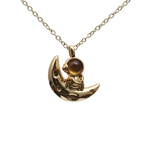 Goldene Halskette mit Astronaut auf dem Mond Anhänger und bernsteinfarbener Kristallverzierung
