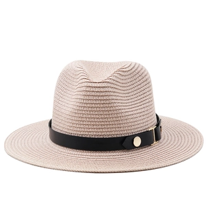 Detail of Panama straw hat featuring a black leather band and golden buckle closure