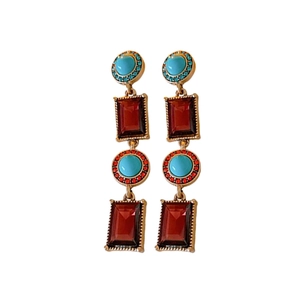 Vintage gold geometric drop earrings featuring red and turquoise stones with beaded details
