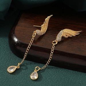 Detail of golden wing tassel earrings with micro-set zircon and teardrop crystal